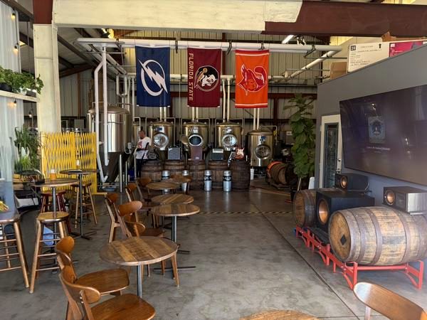 Garage-door room with tables, a barrel and hanging banners