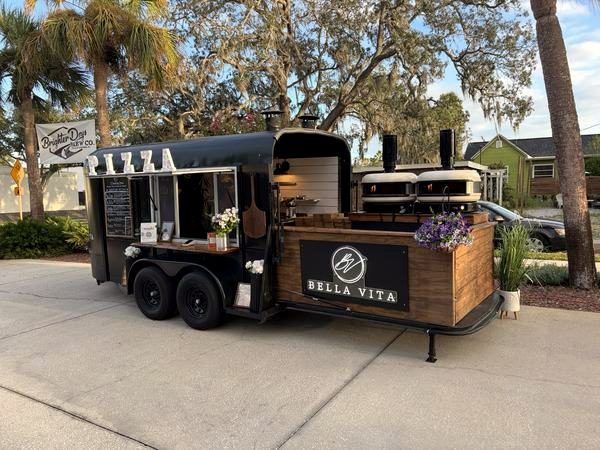 Bella Vita pizza trailer parked by the Brighter Days banner