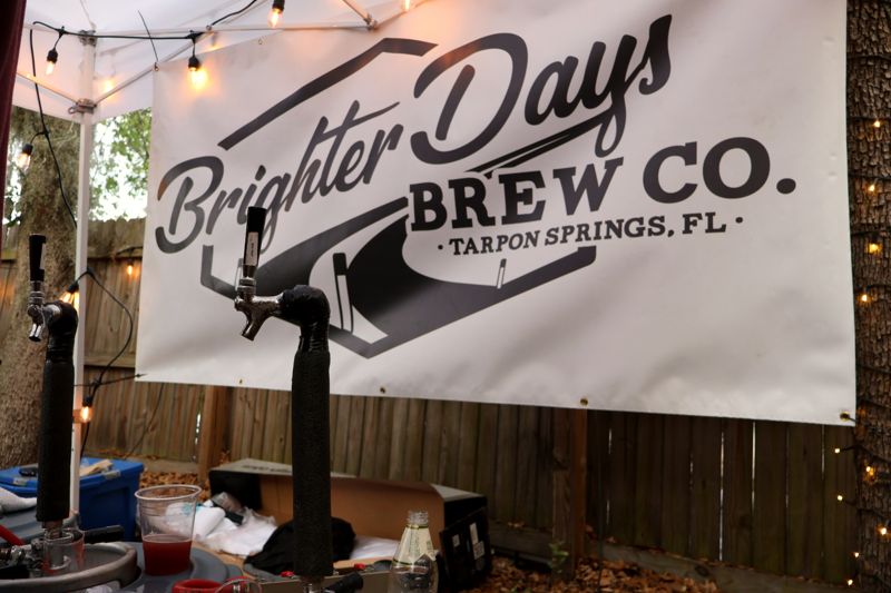 Brighter Days Brew Co. banner and a tap tower at a festival booth under string lights