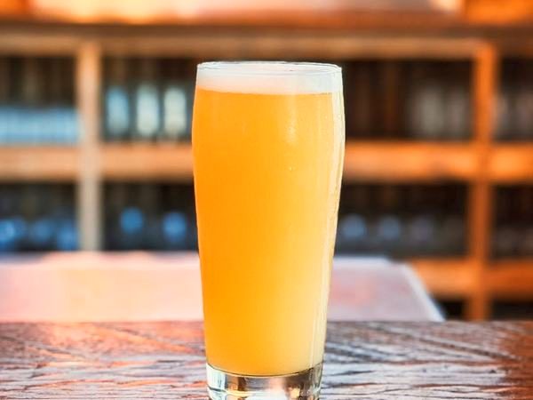 A pint of hazy beer on the bar